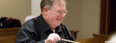 Close up of Bob Webb conducting.